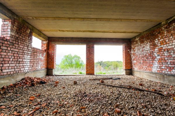 Interior of an old building under construction. Orange brick walls in a new house.